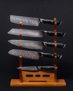 Hasaki Onyx Damascus knife set of five on a wooden rack
